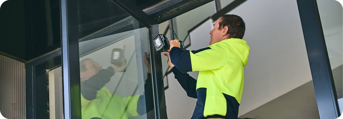 a technician installing a commercial door