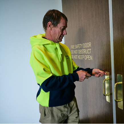 a technician installing a fire door