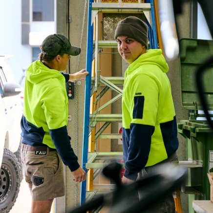 tradesmen with a ladder preparing for work